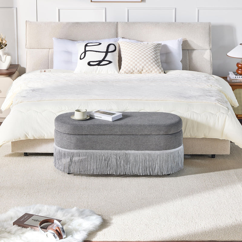 Oval Upholstered Storage Ottoman With Fringe Trim & Lift Top Lid